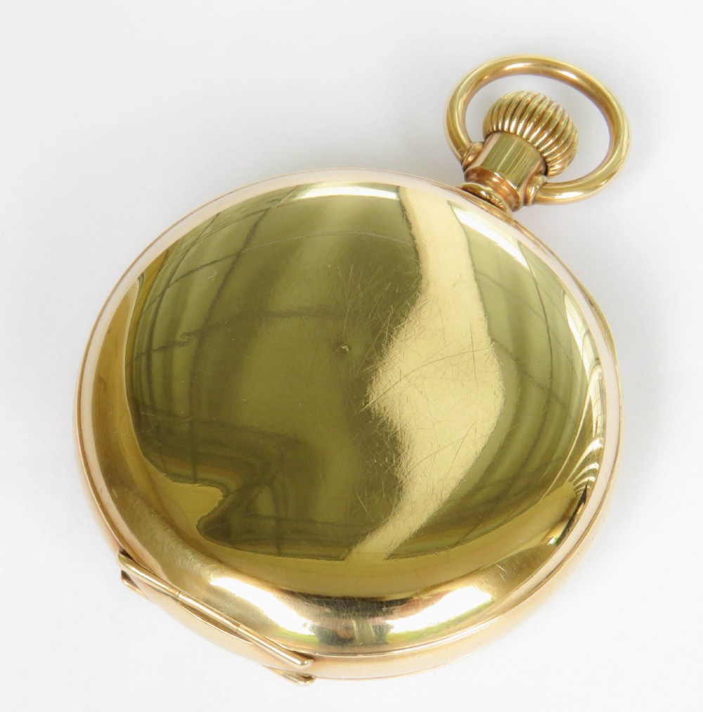 An open-face gold Waltham Traveler pocket watch featuring a white enamel dial with black Roman numerals and a subsidiary seconds dial. View V