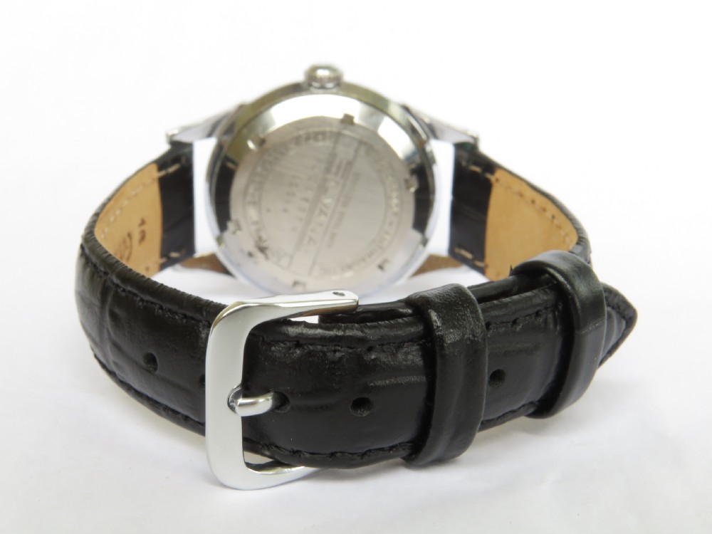 A 1950s gents Silvana automatic wrist watch featuring a metallic steel case, cream dial with a power reserve subdial, and a black leather strap. View V