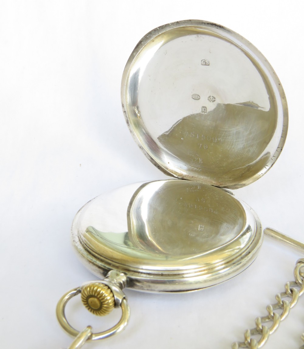 An open-face silver pocket watch featuring a steam locomotive illustration on the white enamel dial, attached to a silver Albert chain with an enamel fob. View IV