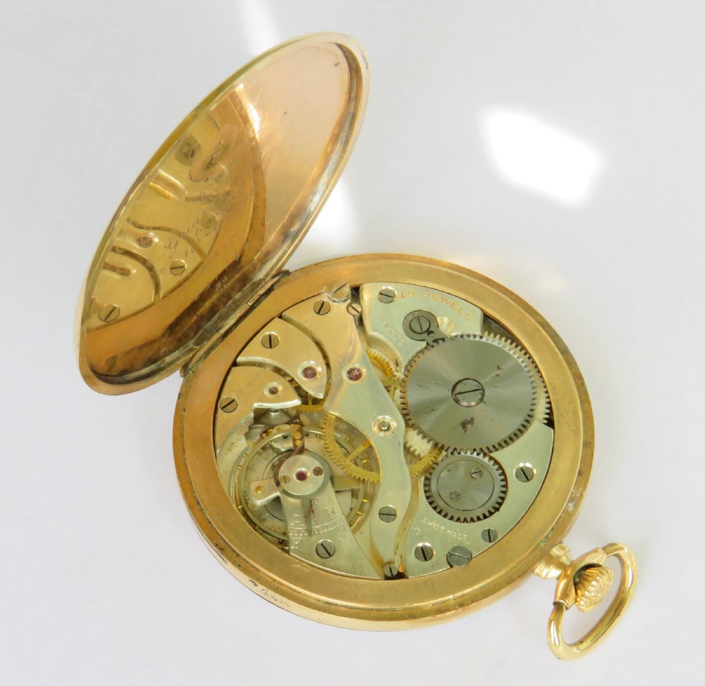 An Art Deco 1920s gold open-face pocket watch by Elkington featuring a textured dial with Arabic numerals. View II