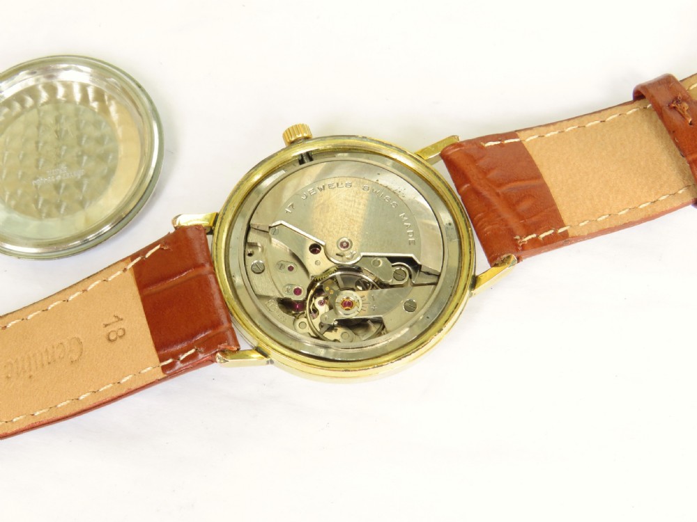 A 1960s Avia DayTyme gents wristwatch featuring a gold-plated case, champagne dial with day and date apertures, and a brown leather strap. View III
