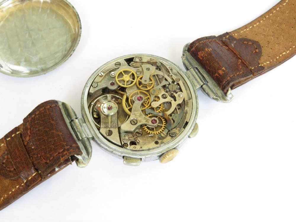 A 1930s gents chronograph wristwatch featuring a patinated cream dial, dual sub-dials, silver-tone case, and a textured brown leather strap. View III