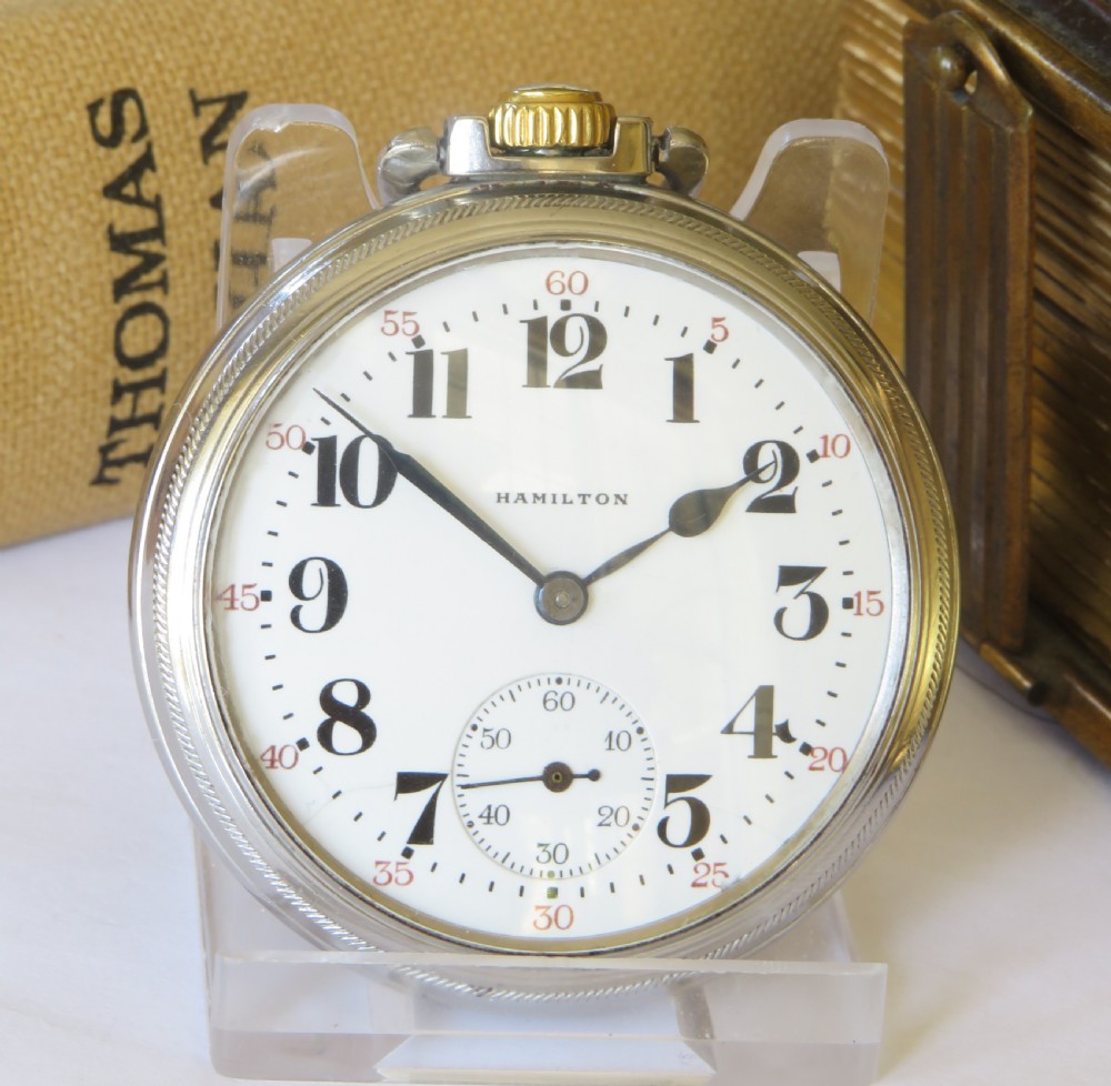 A vintage Hamilton open-face pocket watch featuring a white dial, bold black Arabic numerals, a sub-seconds dial, and a gold-tone crown. View II