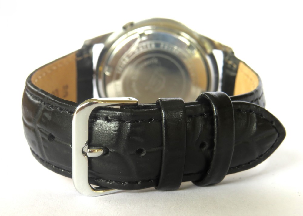 A vintage Seiko Sportsmatic Weekdater automatic wristwatch featuring a round silver dial with a day-date window and a black embossed leather strap. View IV