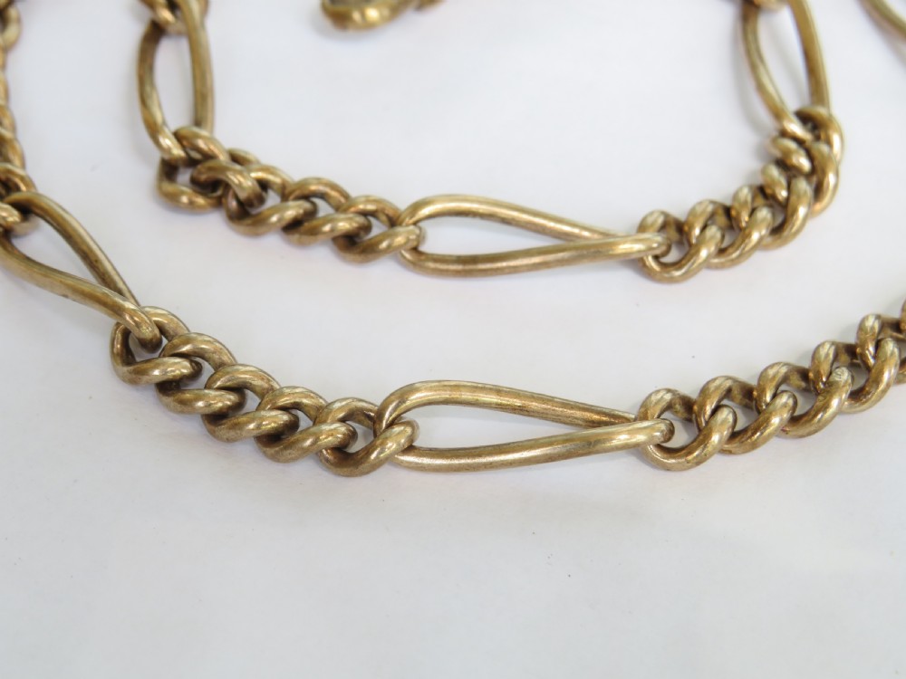 An antique rolled gold double Albert watch chain featuring elongated fetter links, curb chain sections, two swivel clasps, and a central T-bar. View II