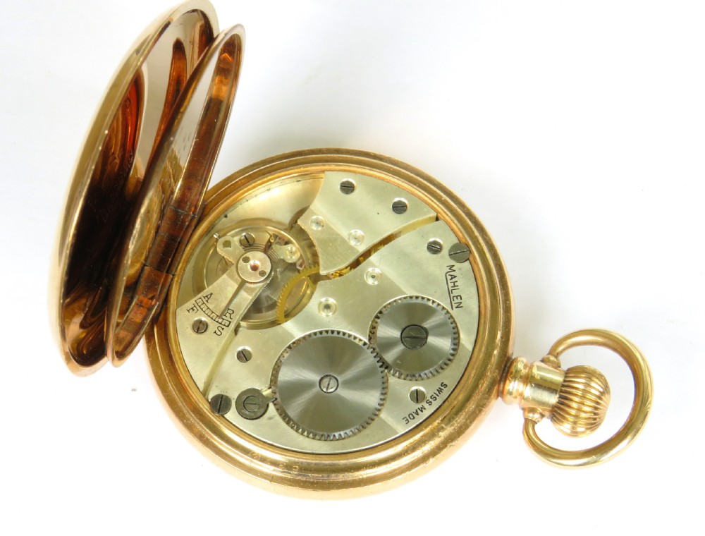 A 1930s gold-toned half hunter pocket watch displayed open, revealing a white dial with black Roman numerals and a subsidiary seconds dial. View V