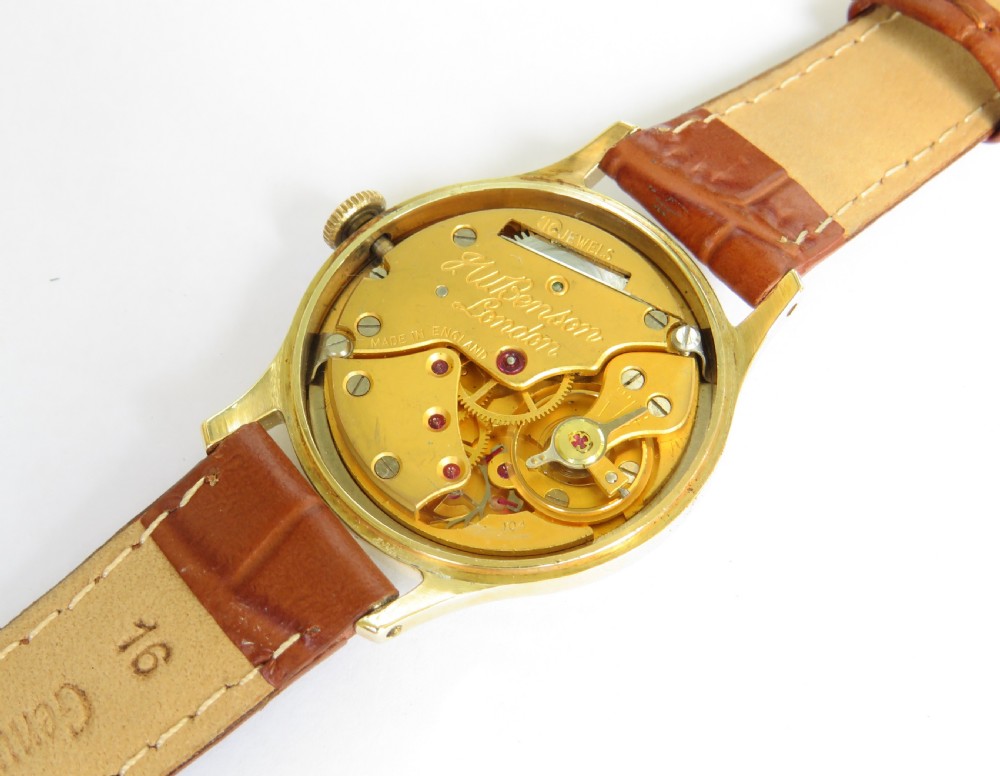 A 1950s gents J W Benson wristwatch with a gold-plated case, cream dial featuring Roman numerals and sub-seconds register, and a brown leather strap. View III