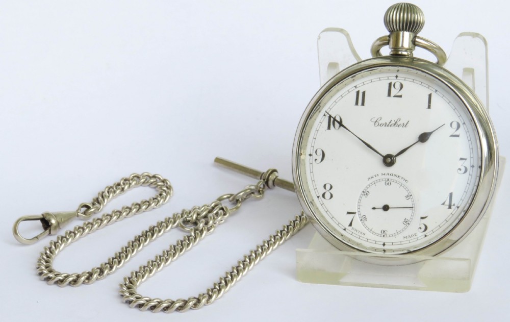 A 1930s open-face Swiss Cortebert pocket watch with a white enamel dial, black numerals, and an attached silver-tone curb link chain. View II