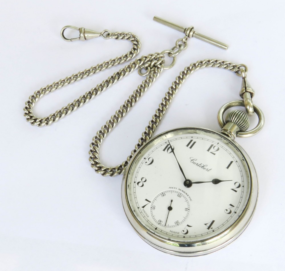 A 1930s open-face Swiss Cortebert pocket watch with a white enamel dial, black numerals, and an attached silver-tone curb link chain. View III