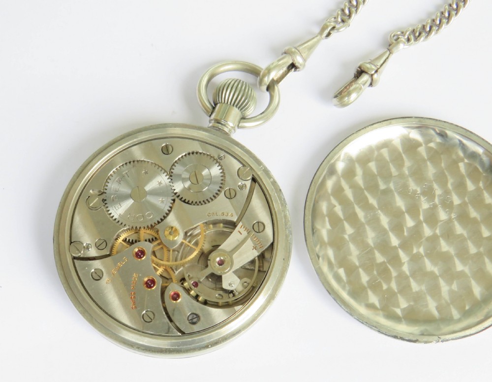 A 1930s open-face Swiss Cortebert pocket watch with a white enamel dial, black numerals, and an attached silver-tone curb link chain. View IV