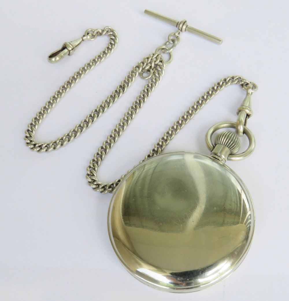 A 1930s open-face Swiss Cortebert pocket watch with a white enamel dial, black numerals, and an attached silver-tone curb link chain. View V
