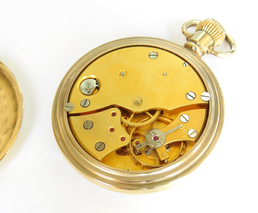 A gold-toned open-faced Smiths De Luxe pocket watch featuring a white dial with Roman numerals and a subsidiary seconds dial. View III