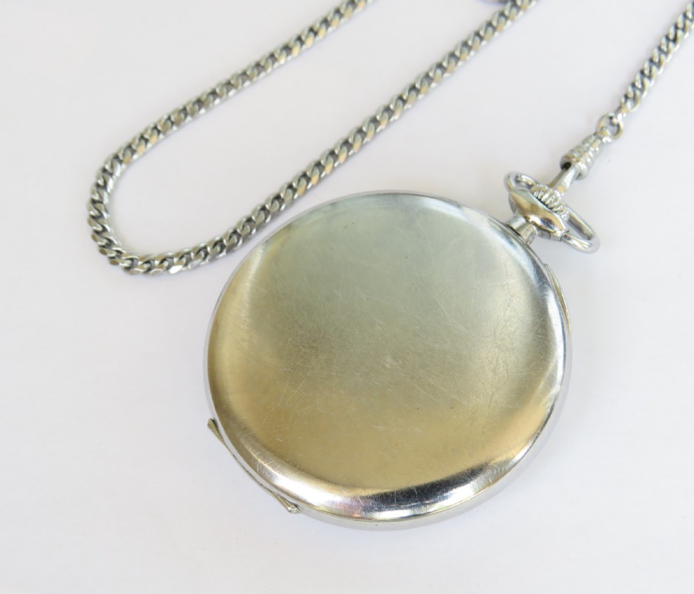 A 1930s open-face Tavannes pocket watch featuring a cream dial with Arabic numerals, a sub-second dial, and a silver-tone curb chain. View IV