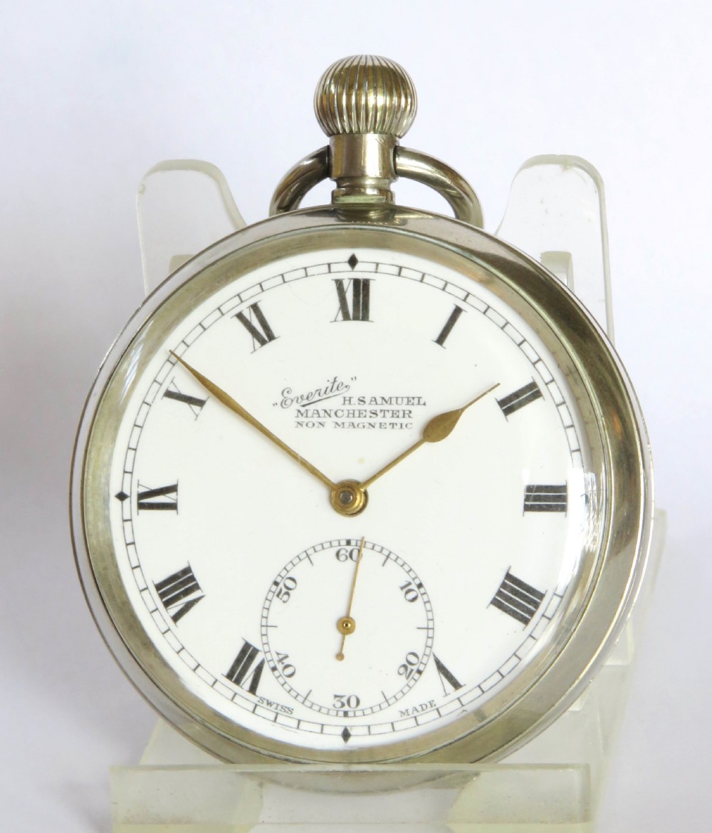 A 1930s open-face pocket watch featuring a white dial with black Roman numerals, sub-seconds dial, gold-toned hands, and a polished silver-coloured metal case. View II