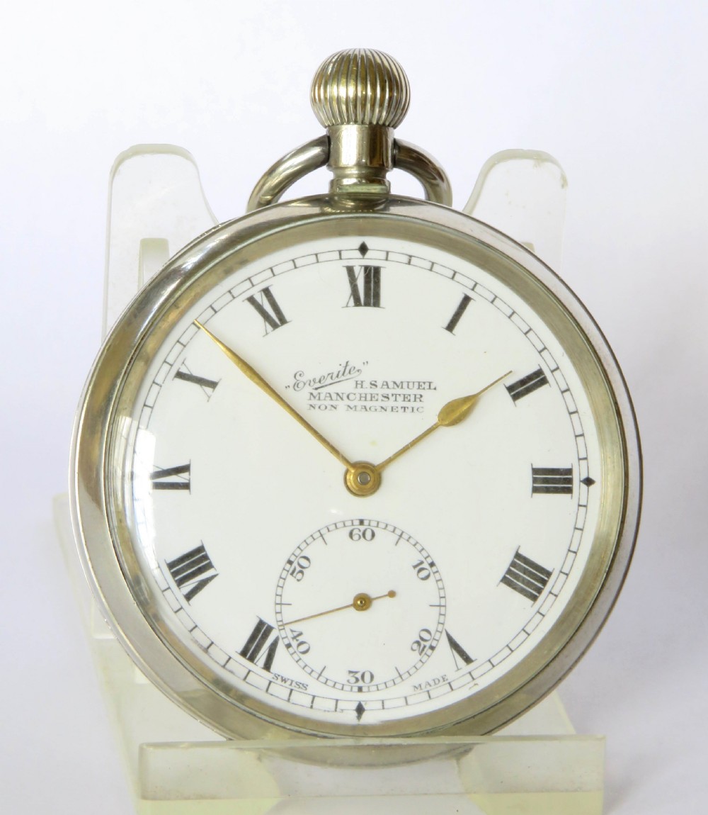 A 1930s open-face pocket watch featuring a white dial with black Roman numerals, sub-seconds dial, gold-toned hands, and a polished silver-coloured metal case. View III