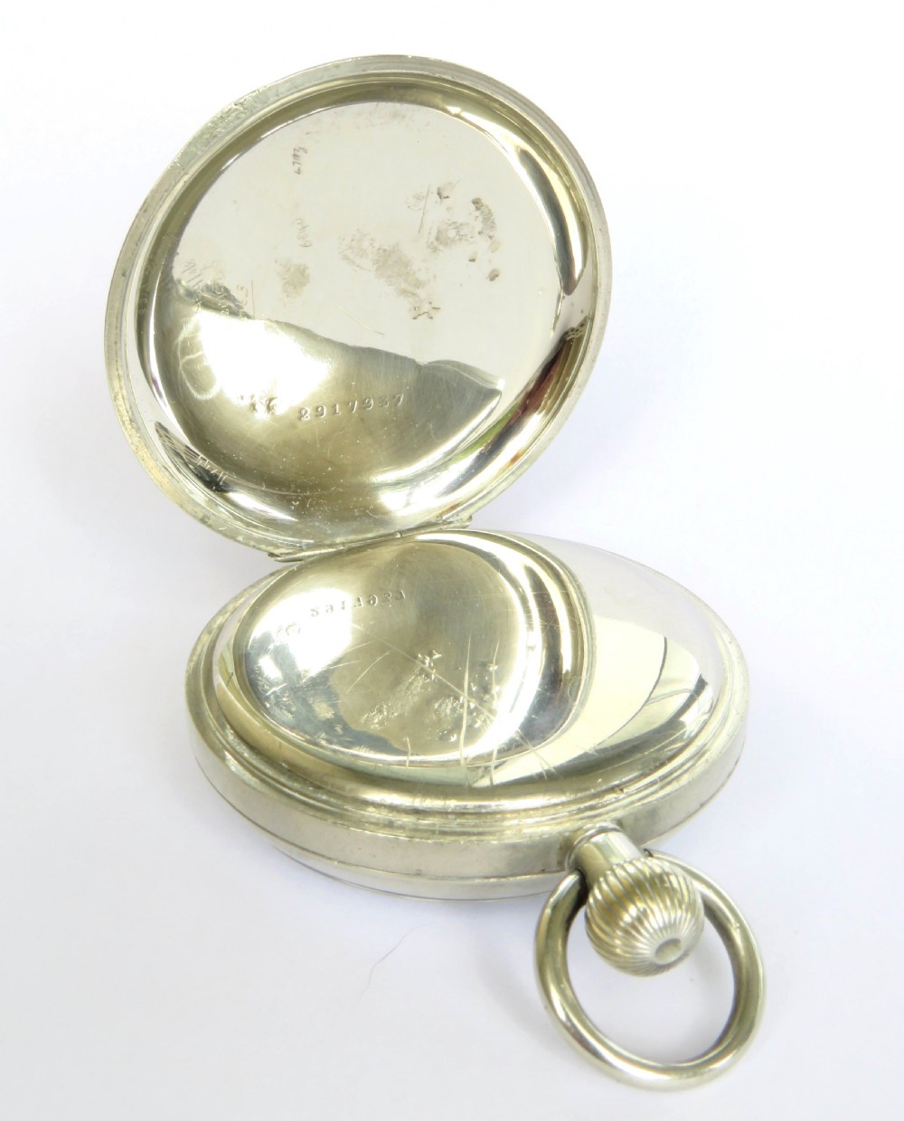 A 1930s open-face pocket watch featuring a white dial with black Roman numerals, sub-seconds dial, gold-toned hands, and a polished silver-coloured metal case. View IV