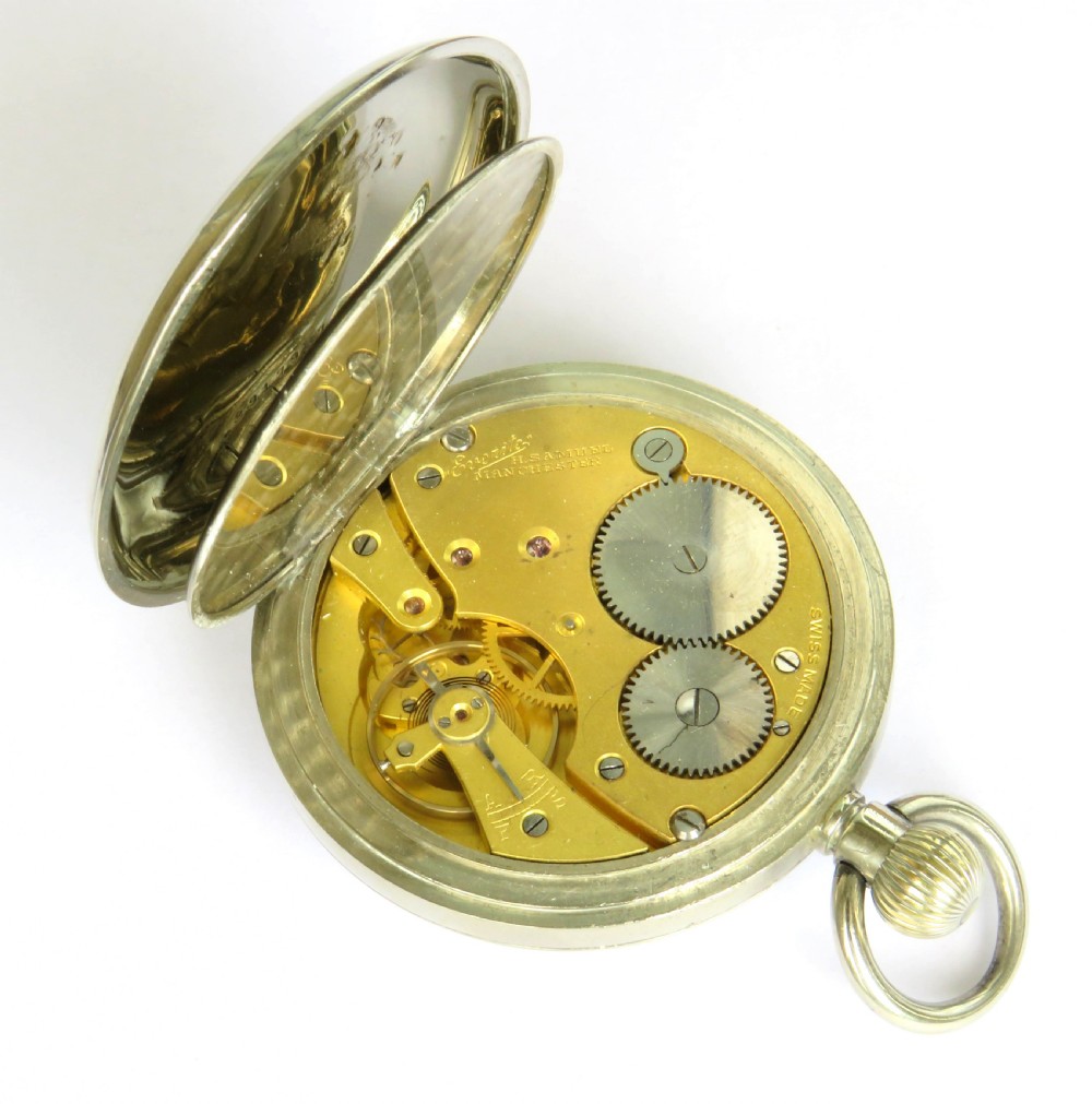 A 1930s open-face pocket watch featuring a white dial with black Roman numerals, sub-seconds dial, gold-toned hands, and a polished silver-coloured metal case. View V