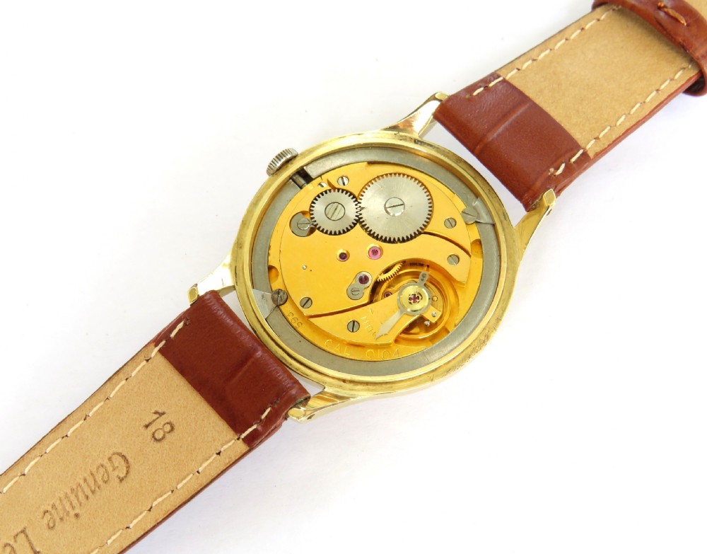 A gents gold-plated circular wristwatch with a cream dial, gold Arabic numerals, red-tipped second hand, and brown leather strap. View III