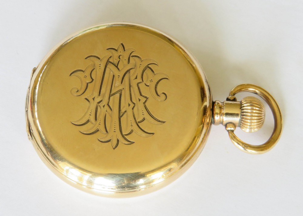 An opened gold antique full hunter pocket watch displaying a white enamel dial with black Roman numerals and a subsidiary seconds dial. View V