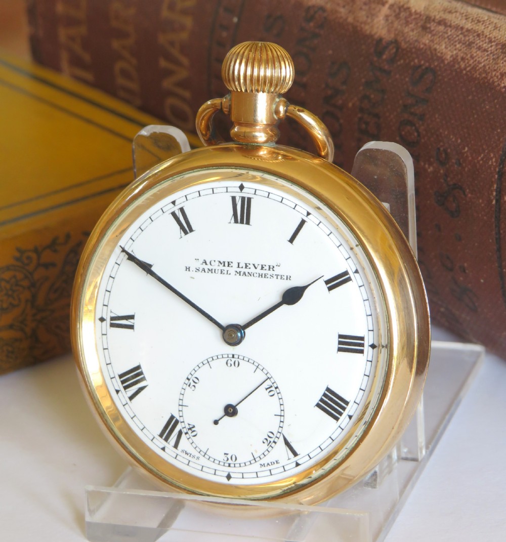 An open-face antique gold-toned pocket watch with a white enamel dial, black Roman numerals, and a subsidiary seconds display.