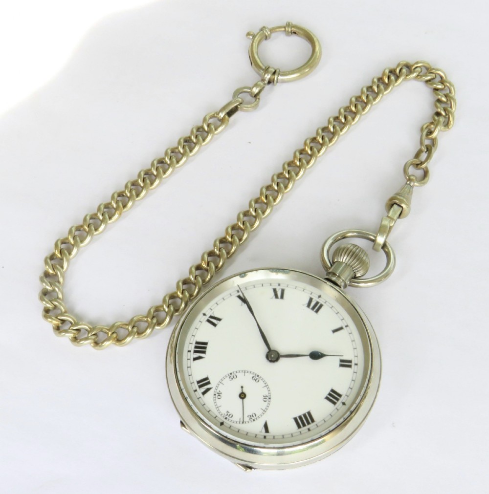 An open face silver pocket watch featuring black Roman numerals on a white enamel dial with an attached brass curb chain. View III