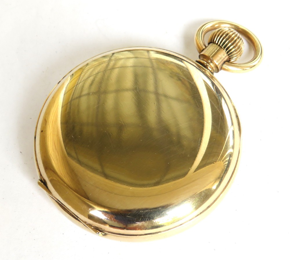 A 1930s gold-toned open-face pocket watch featuring a white dial, bold black Arabic numerals, and a small subsidiary seconds dial at the bottom. View V