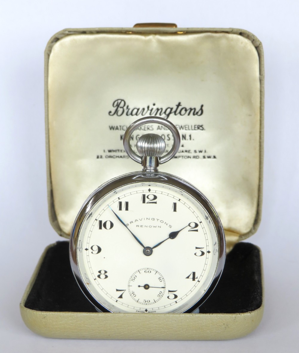 A 1950s Bravingtons Renown open-face pocket watch with a cream dial, black Arabic numerals, and blued steel hands, set inside its cream presentation case.