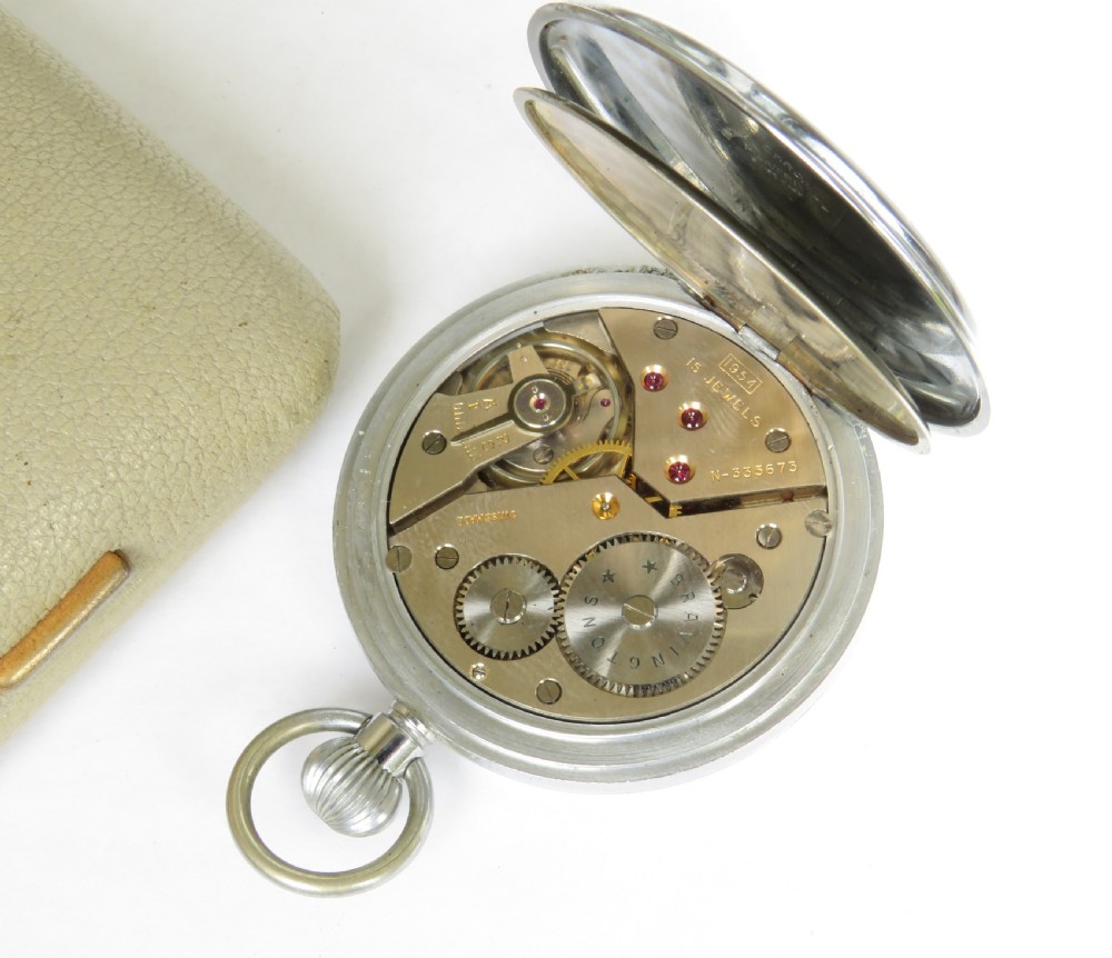 A 1950s Bravingtons Renown open-face pocket watch with a cream dial, black Arabic numerals, and blued steel hands, set inside its cream presentation case. View IV