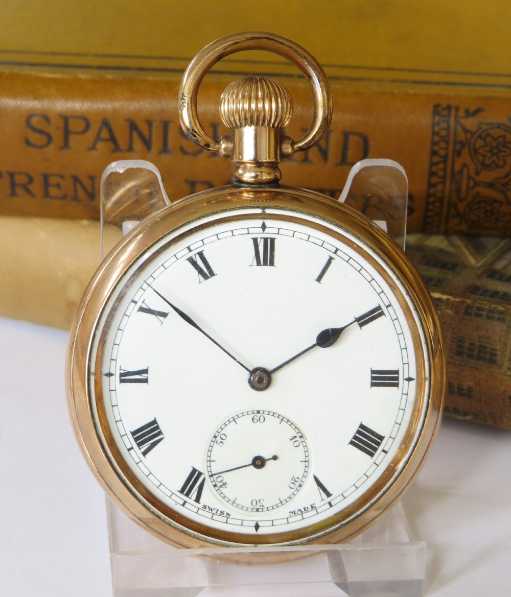 A 1920s Swiss open-face pocket watch featuring a gold-toned case, a white dial with black Roman numerals, and a subsidiary seconds dial at the six oclock position. View II