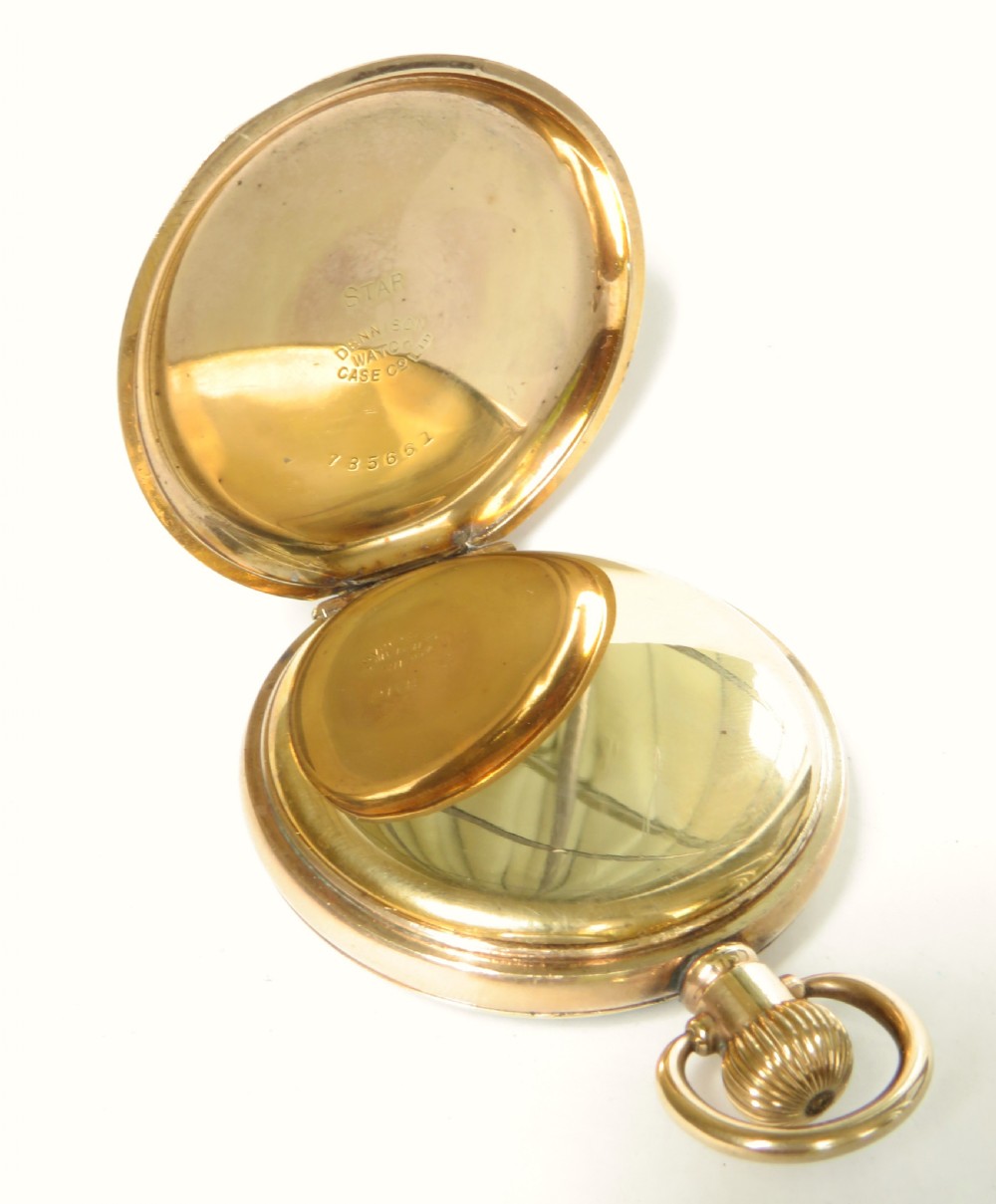 A 1920s Swiss open-face pocket watch featuring a gold-toned case, a white dial with black Roman numerals, and a subsidiary seconds dial at the six oclock position. View III