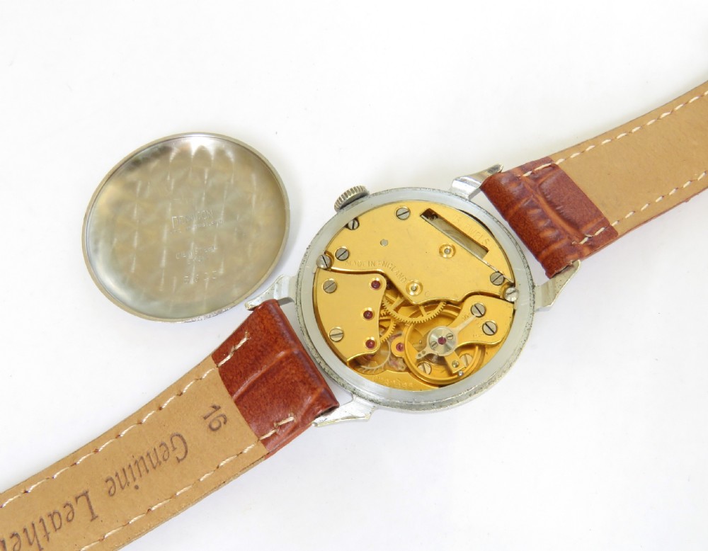 A mid-20th-century gents Smiths wristwatch featuring a champagne dial with Roman numerals, subsidiary seconds dial, silver-tone case, and tan leather strap. View III