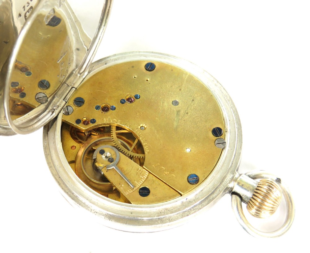 An antique open-face silver pocket watch featuring a white enamel dial with black Roman numerals and a small seconds sub-dial at six oclock. View IV
