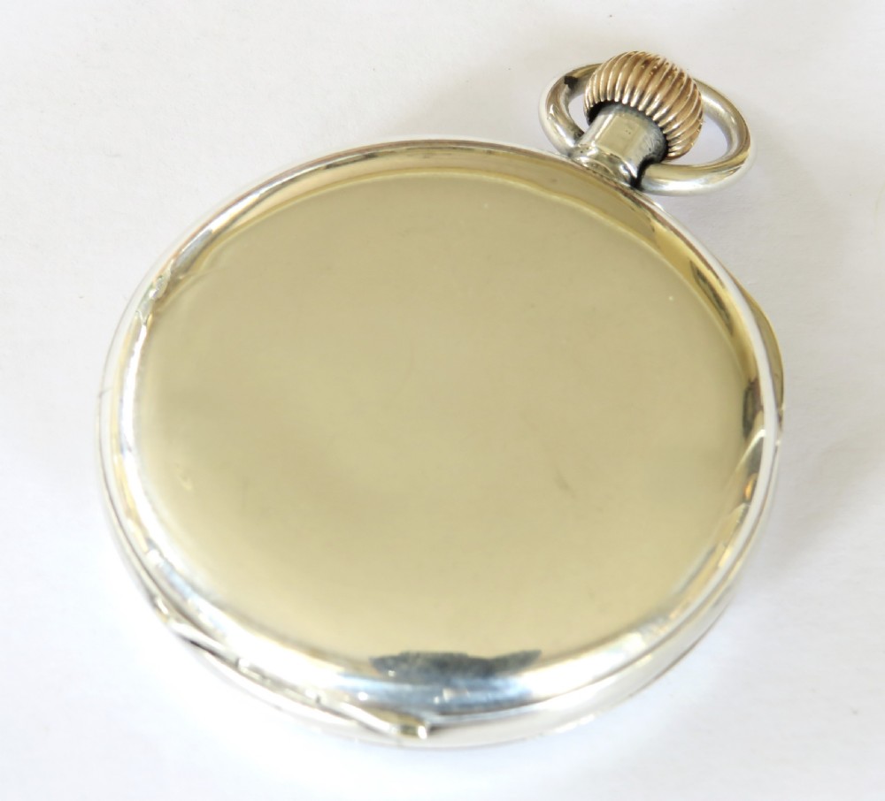 An antique open-face silver pocket watch featuring a white enamel dial with black Roman numerals and a small seconds sub-dial at six oclock. View V