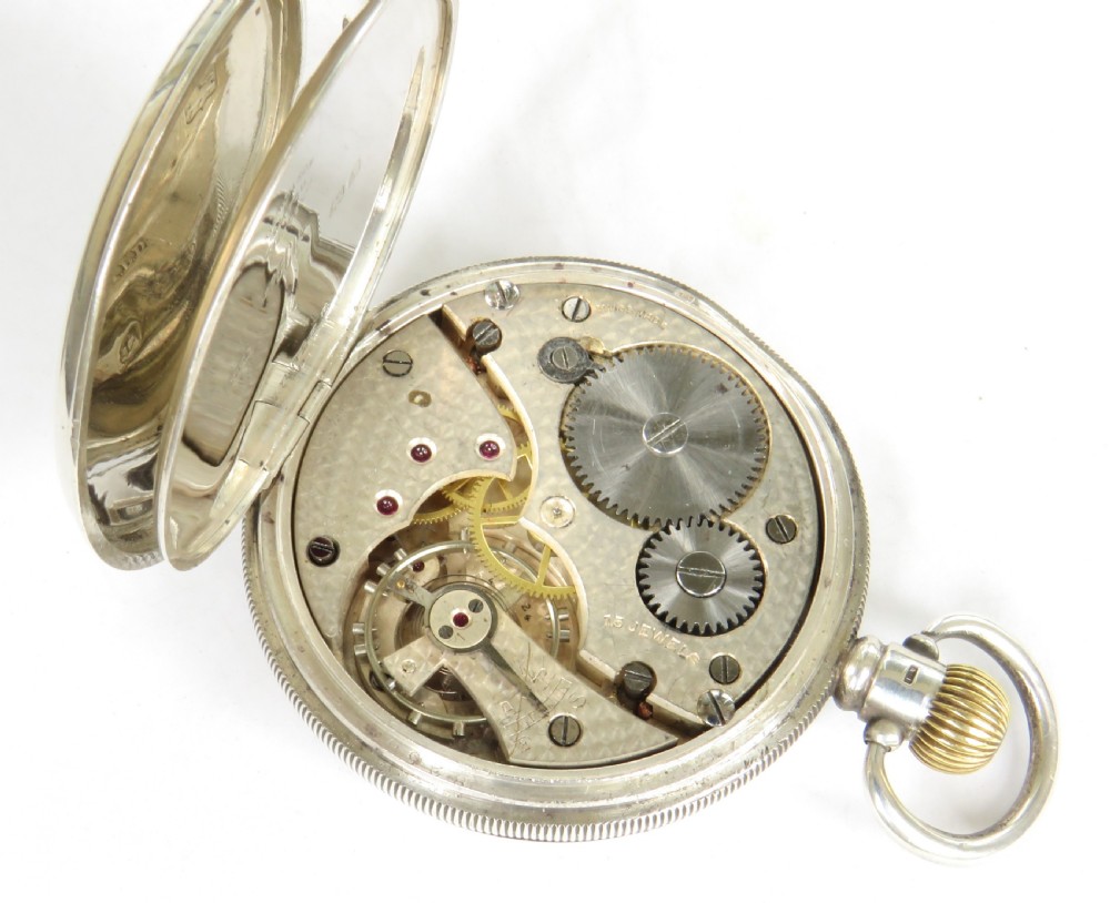 An open-face silver pocket watch with a white enamel dial, black Arabic numerals, and a sub-seconds dial. View IV