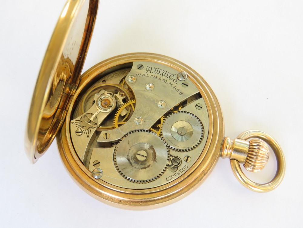An open gold-toned full hunter pocket watch displaying a white enamel dial with black Roman numerals and a subsidiary seconds dial. View III