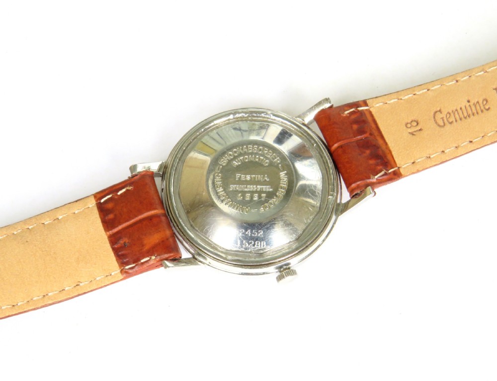 A gents 1950s Festina automatic wristwatch featuring a champagne dial, silver-tone case, and brown leather strap. View IV