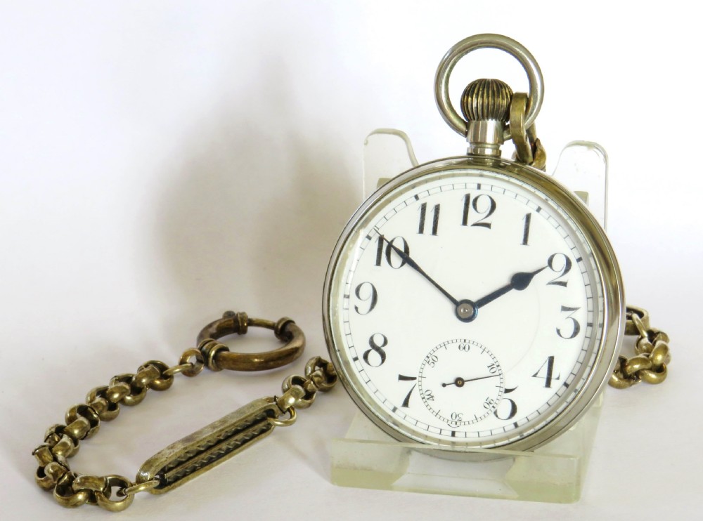An antique silver-tone Octava 8-day open-face pocket watch featuring a white enamel dial with black Arabic numerals and an attached chain. View II