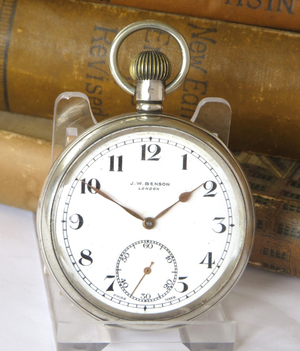 A silver open-face pocket watch with a white enamel dial, black Arabic numerals, and a small subsidiary seconds subdial at six oclock. View II