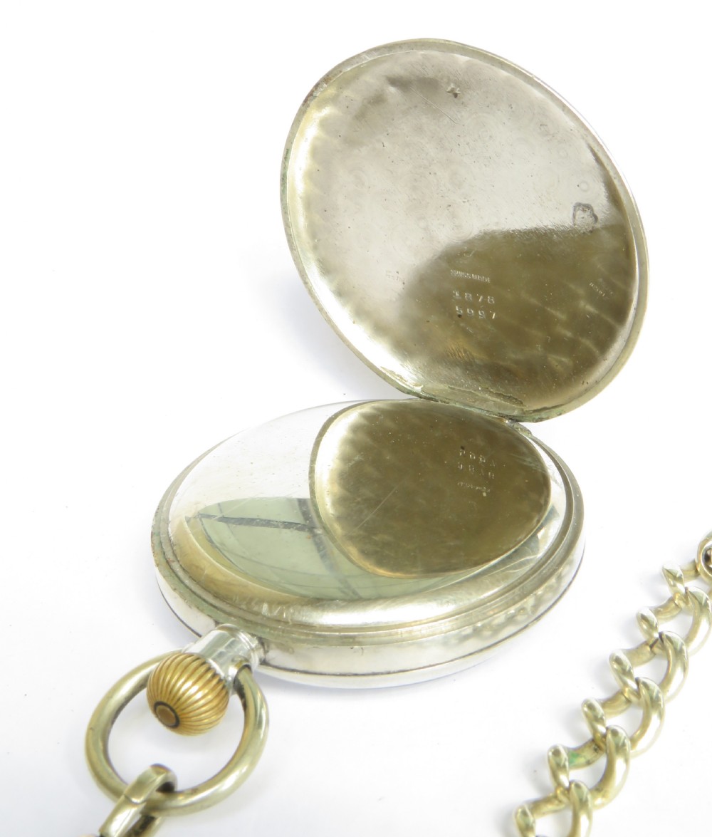 A 1920s Cyma open-face pocket watch featuring a white enamel dial with black Arabic numerals, a sub-seconds dial, and an attached link chain with a T-bar. View II