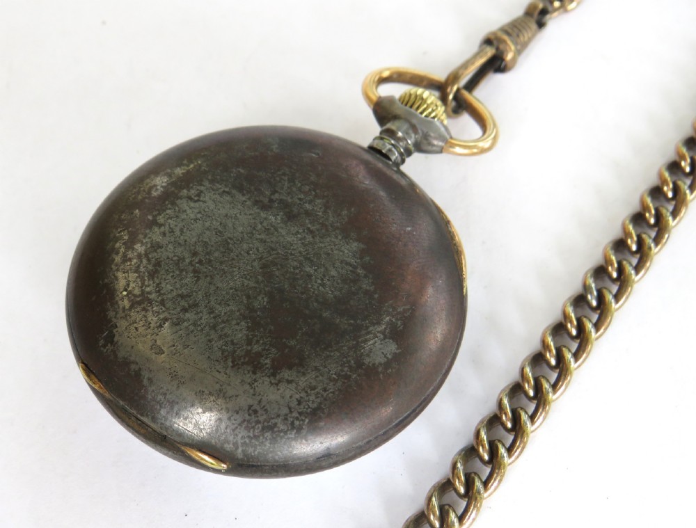 An antique open-face pocket watch with a white enamel dial and black Arabic numerals, attached to a brass curb-link Albert chain with a T-bar. View V