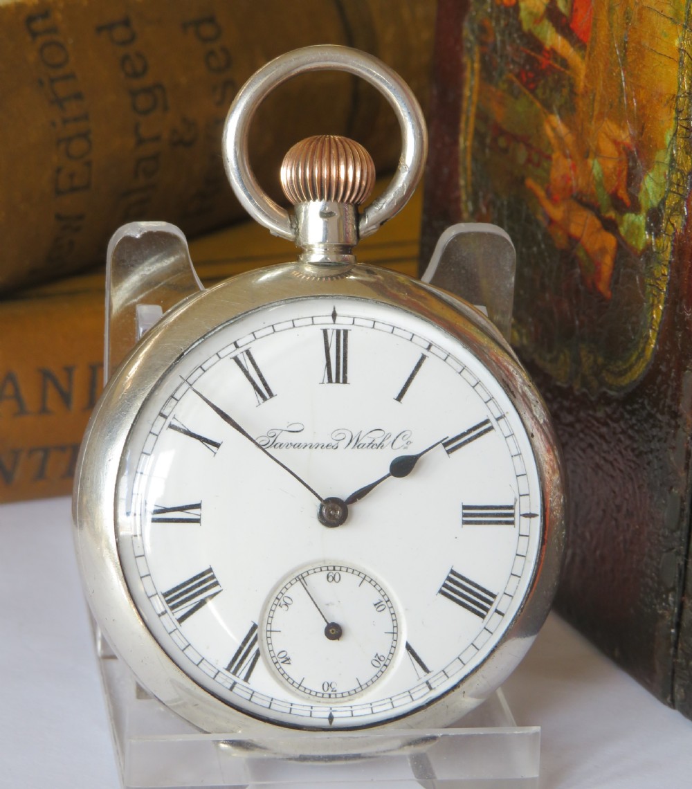 An antique silver open-face pocket watch featuring a white enamel dial with Roman numerals and a subsidiary seconds dial. View II