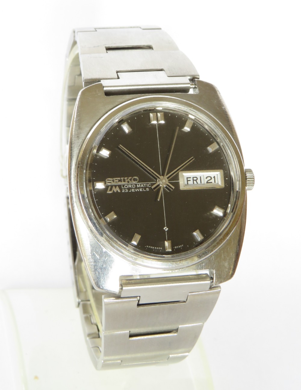 A gents Seiko Lord Matic stainless steel automatic wristwatch featuring a black dial face with day-date display and integrated steel link bracelet. View II