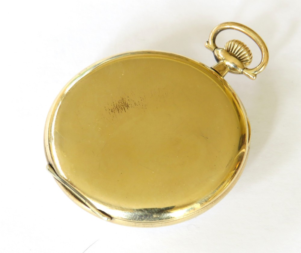 A 1930s gold-tone open-face pocket watch featuring a white enamel dial, black Arabic numerals, a sub-seconds dial at six oclock, and signature marked Thomas Russell and Son Liverpool. View V