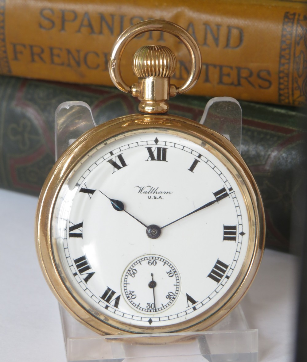 An open-face antique gold-tone pocket watch featuring a white enamel dial with black Roman numerals and a subsidiary seconds sub-dial. View II