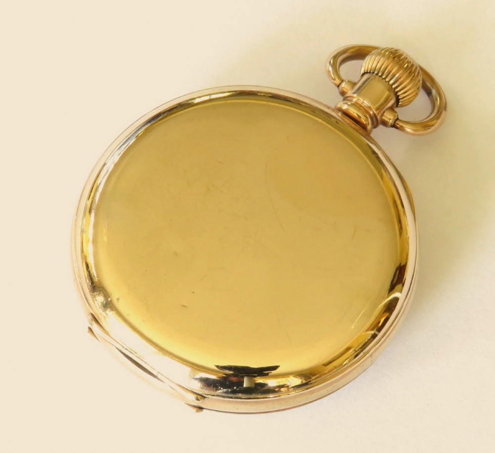 An open-face antique gold-tone pocket watch featuring a white enamel dial with black Roman numerals and a subsidiary seconds sub-dial. View V