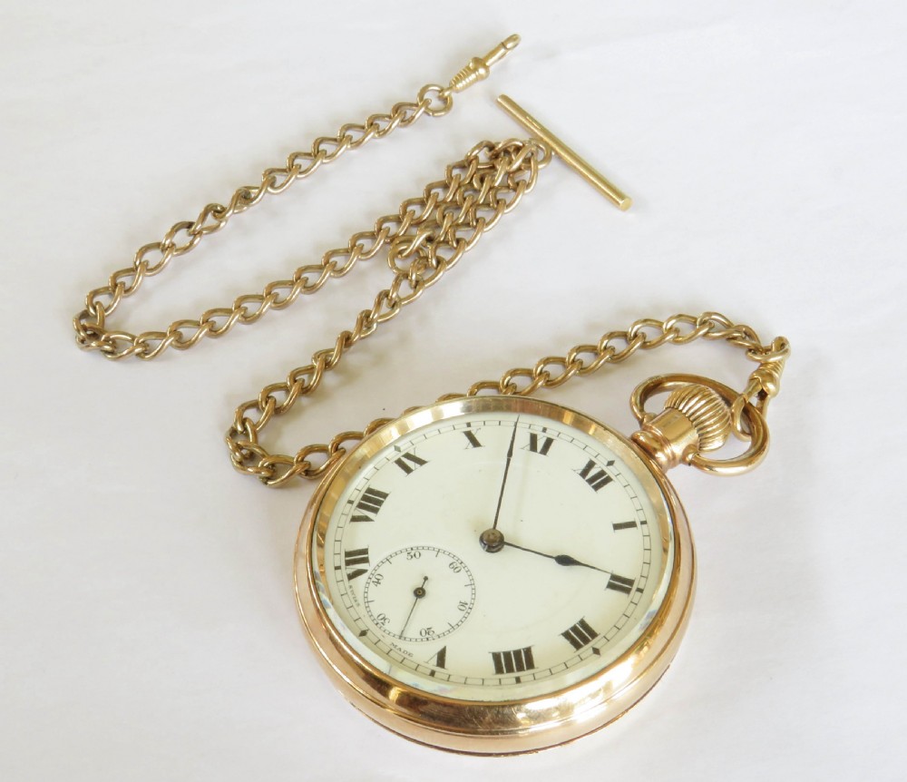 An antique gold-toned open-face pocket watch featuring a white enamel dial with black Roman numerals, blued steel hands, a subsidiary seconds dial, and an attached gold-toned Albert chain. View III