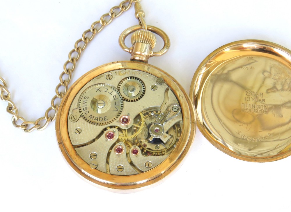 An antique gold-toned open-face pocket watch featuring a white enamel dial with black Roman numerals, blued steel hands, a subsidiary seconds dial, and an attached gold-toned Albert chain. View IV