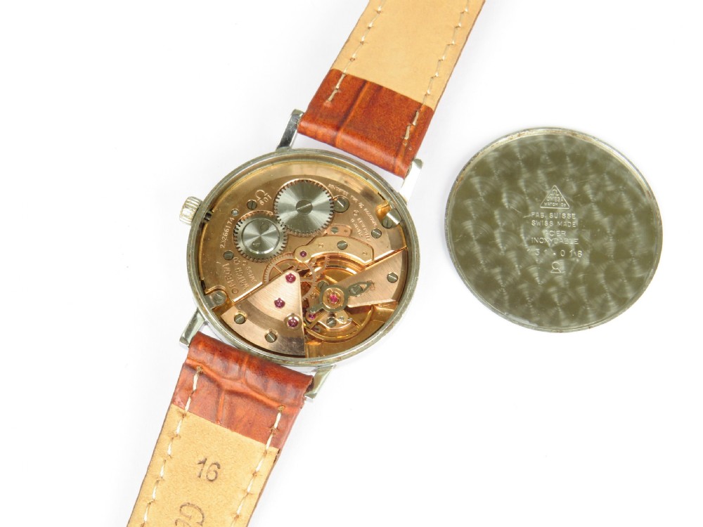 A 1966 Omega Geneve wristwatch featuring a round silver-toned dial, black baton indices, and a textured brown leather strap. View IV