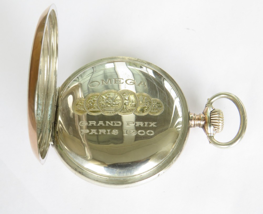 An antique open-face silver pocket watch featuring a white enamel dial with black Arabic numerals and a subsidiary seconds dial at six oclock. View III