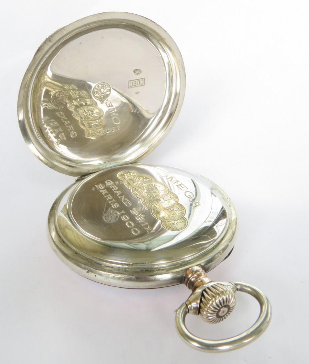 An antique open-face silver pocket watch featuring a white enamel dial with black Arabic numerals and a subsidiary seconds dial at six oclock. View IV